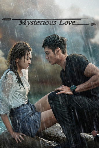 The poster captures a tender moment between two characters in a rain-slicked, moody setting. The warm tones of their clothing contrast with the cool, overcast background, creating an intimate atmosphere.