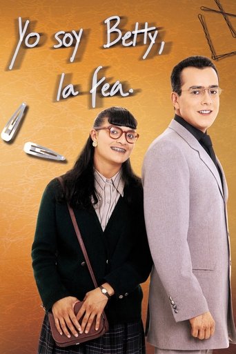 The poster features Betty and her friend in a warm, inviting scene against a soft orange background. Betty wears glasses and a black cardigan, while her friend sports a light gray blazer. The mood is cheerful and friendly, capturing the essence of their friendship.