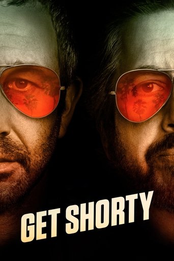 The poster features two men in sunglasses, one with a serious expression and the other with a more intense gaze. The red tint of their lenses adds a dramatic and intense atmosphere, while the bold text "GET SHORTY" at the bottom suggests a gritty, action-oriented theme.