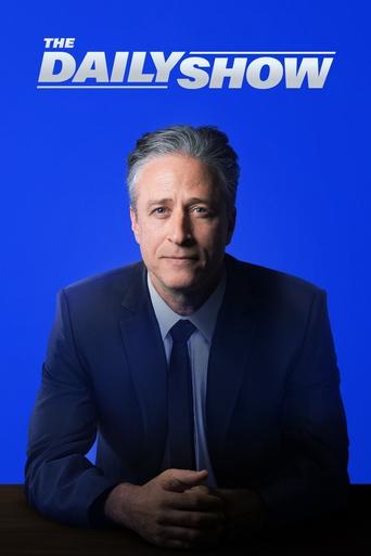The Daily Show poster features a man in a sharp suit against a vibrant blue background, exuding professionalism and authority. The bold, white title stands out prominently, suggesting a serious and engaging television show. The overall composition conveys a sense of intellectual curiosity and ent...