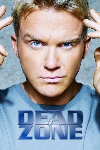 The poster features a grumpy, intense man with blonde hair and blue eyes, holding his hands up to his ears. His expression conveys frustration or annoyance, while the bold blue text "DEAD ZONE" dominates the lower portion of the image. The muted background and dramatic lighting emphasize the char...