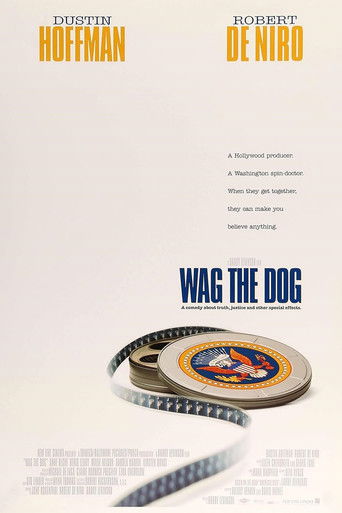 The poster features two actors, Dustin Hoffman and Robert De Niro, with their names prominently displayed in bold orange text. The film's title, "Wag the Dog," is written in large blue letters below a film reel. The overall design is clean and minimalistic, with a muted color palette that evokes ...