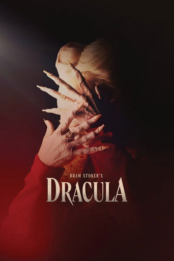 The poster features a hauntingly beautiful blonde woman with pale skin, her face partially obscured by a hand holding a sharp, glowing dagger. The deep red background and dramatic lighting create an eerie, supernatural atmosphere, evoking the classic vampire tale.