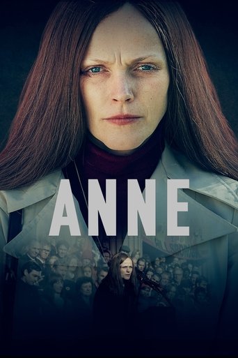 The poster features a woman with long dark hair, wearing a trench coat, set against a dark background. The word "ANNE" is prominently displayed in bold white letters. The overall mood is mysterious and dramatic.