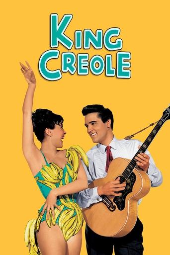 The poster features a vibrant yellow background with the title "King Creole" in bold, playful lettering. A man in a white shirt and tie plays an acoustic guitar while a woman in a yellow bikini dances joyfully beside him. Their expressions convey a sense of fun and camaraderie, suggesting a light...