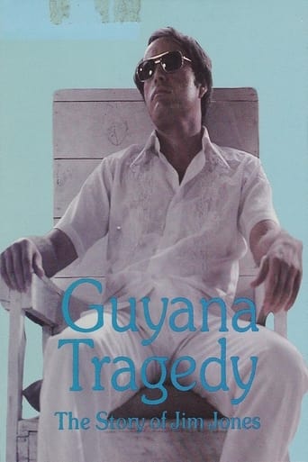 The poster features a man in sunglasses, sitting in a wooden chair against a soft blue background. The title "Guyana Tragedy" is prominently displayed in large teal letters, with the subtitle "The Story of Jim Jones" below. The overall mood is somber and reflective, capturing the essence of the t...
