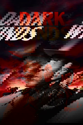 The poster features a somber, dramatic scene with three characters in dark uniforms against a fiery, ominous sky. The title "Dark Winds" is prominently displayed in bold, red letters. The overall mood is tense and foreboding, suggesting a thrilling action or crime drama.