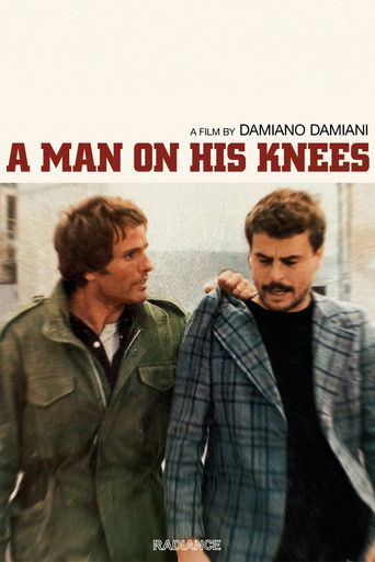 The poster features two men in a tense, dramatic pose against a muted background. The warm tones of their clothing and the soft lighting evoke a sense of mystery and emotional weight. The title, "A Man on His Knees," hints at a story of personal struggle and connection.