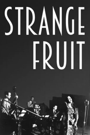 The poster features a black-and-white image of a band performing on stage, with the title "STRANGE FRUIT" prominently displayed in bold white letters. The mood is mysterious and atmospheric, evoking a sense of intrigue and perhaps a bit of melancholy.