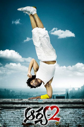 The poster features a dynamic shot of a person in a white outfit performing a handstand against a vibrant blue sky with fluffy white clouds. The bold red and black text "Aarya 2" at the bottom emphasizes the film's title. The overall mood is energetic and adventurous, capturing the essence of act...