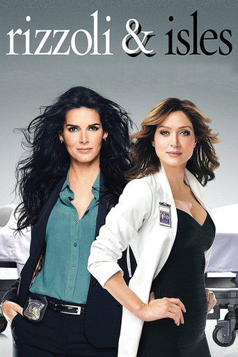 The poster features two women in professional attire against a dark, moody background. The woman on the left wears a teal shirt and black pants, while the woman on the right dons a white blazer over a black top. Their confident expressions and poised stances convey a sense of authority and intrig...