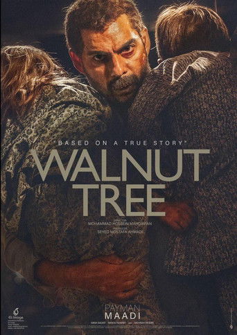 The poster features a gritty, textured image of a man in a dark jacket surrounded by other characters, evoking a somber and intense mood. The muted color palette and shadowy tones enhance the film's serious tone, while the bold, distressed typography of "WALNUT TREE" reinforces the gritty, raw na...