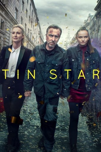 The poster features three men walking down a cobblestone street, with a dramatic, moody atmosphere. The warm golden text "TIN STAR" stands out against the cool, muted tones of the scene.