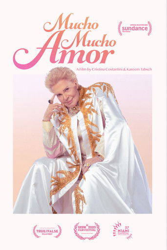 The poster features a glamorous woman in a white gown with gold patterns, exuding elegance and confidence. The warm pink background complements the golden accents, creating a romantic and luxurious atmosphere. The title "Mucho Mucho Amor" is prominently displayed in bold, elegant script, emphasiz...