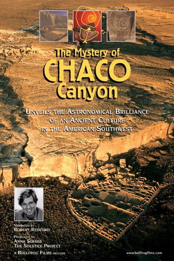 The poster features a dramatic desert landscape with warm golden hues and rugged textures, evoking a sense of mystery and adventure. A small black-and-white portrait of a man appears in the bottom left corner, adding a personal touch to the film's exploration of ancient history.