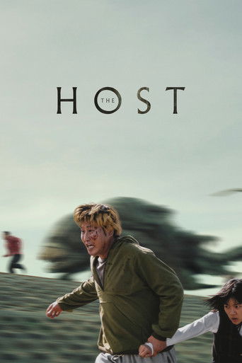 The poster features a man in a green jacket running toward the viewer, with a blurred figure in the background. The muted earthy tones and soft lighting evoke a sense of urgency and motion, while the bold typography of "THE HOST" suggests a thriller or suspense genre.