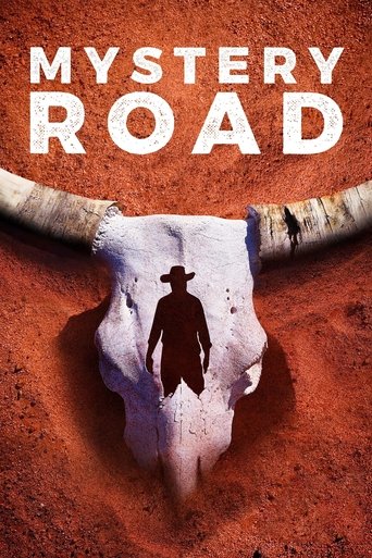 The poster features a silhouette of a cowboy walking through a rugged, reddish-brown landscape, evoking a sense of adventure and mystery. The title "Mystery Road" is prominently displayed in bold white letters above the image. The overall mood is adventurous and intriguing, suggesting a thrilling...