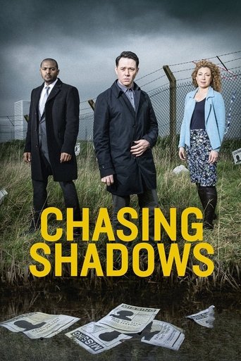 The poster features three men and a woman standing in a grassy field under a moody, overcast sky. The title "CHASING SHADOWS" is prominently displayed in bold yellow letters. The mood is suspenseful and dramatic, with a sense of mystery and intrigue.