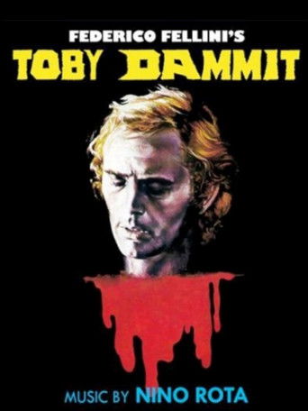 The poster features a menacing face against a stark black background, with the title "Toby Dammit" in bold yellow letters. A dripping red blood effect adds a sinister touch, while the name "Federico Fellini's" hints at the film's directorial flair. The overall mood is dark and ominous, evoking a ...