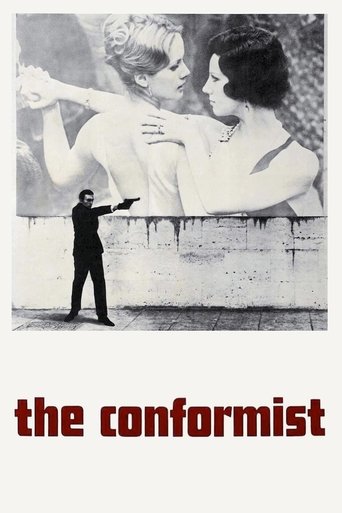 The poster features a striking black-and-white image of two women embracing passionately, with a man in a suit holding a gun in the foreground. The mood is intense and dramatic, capturing the essence of the film's themes of conformity and rebellion. The title "the conformist" is boldly displayed ...