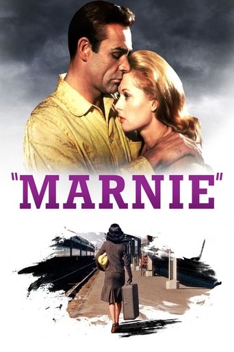 The poster features a dramatic scene with a man in a yellow shirt and a woman in a pink dress, their faces close together against a cloudy sky. Below, a silhouette of a woman walks away from the viewer, evoking a sense of mystery and romance. The title "MARNIE" is prominently displayed in bold pu...