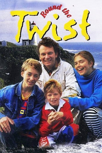 The poster features three people—two boys and a man—posing outdoors with a scenic backdrop of water and hills. The vibrant colors of the men's clothing contrast with the blue tones of the ocean. The mood is lighthearted and adventurous, capturing the essence of a family enjoying a seaside adventure.