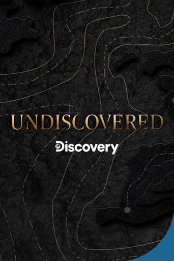 The poster features a mysterious, dark background with faint, golden line art resembling a map or topographic sketch. The title "Undiscovered" is prominently displayed in elegant gold lettering, while the word "Discovery" appears below in a smaller, white font. The overall mood is one of intrigue...
