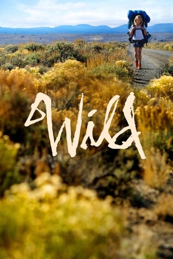 A lone hiker stands on a dirt path in a golden desert landscape, carrying a backpack, with the word "Wild" written in white script across the foreground. The scene captures a sense of adventure and freedom, evoking a warm, inviting mood.