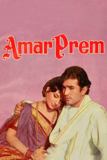 The poster features a romantic couple in traditional Indian attire, with the title "Amar Prem" prominently displayed in bold red letters. The warm pink background and intimate expressions evoke a sense of nostalgia and romance.