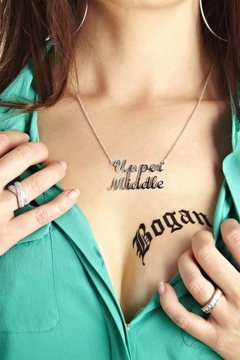 A woman in a teal shirt displays bold black tattoos on her chest: "Upper Middle" and "Bogan." Her hands rest near her collarbone, fingers slightly curled. The image conveys a mix of confidence and boldness, with the vibrant teal contrasting against the stark black text.