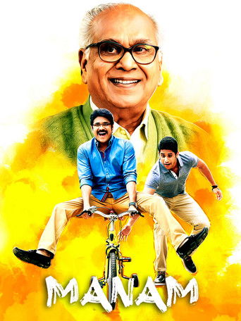 The poster features a smiling man in glasses at the top, with two younger men riding a bicycle below him. The background is a vibrant yellow, and the title "MANAM" is prominently displayed at the bottom. The overall mood is energetic and joyful.