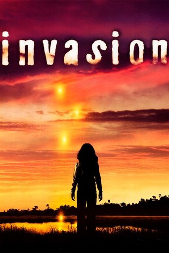 The poster features a silhouetted figure against a dramatic sunset, evoking mystery and suspense. The title "Invasion" is prominently displayed in bold, fiery letters, suggesting themes of conflict and danger. The warm colors of the sky create an intense and emotional atmosphere, hinting at a thr...
