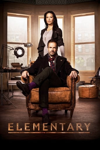 The poster features a man and woman in a cozy, vintage-styled room with warm lighting. The man sits comfortably in a leather armchair while the woman stands behind him, both exuding confidence and charm. The rich browns and warm tones create an inviting atmosphere, suggesting a blend of humor and...