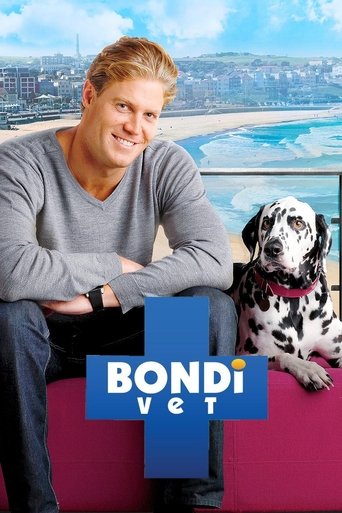 A smiling man in a gray sweater sits on a pink couch beside a Dalmatian dog, exuding warmth and friendliness. The vibrant blue and pink tones of the couch and the show's logo create a cheerful, inviting atmosphere.