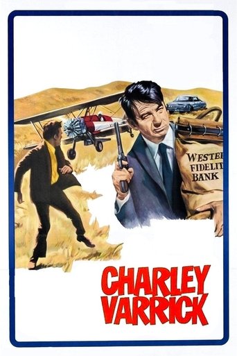 The poster features a dramatic scene with a man in a suit pointing forward, set against a backdrop of a desert landscape. A figure in black runs away from the viewer, while another figure in a red suit flies through the sky. The color palette includes warm yellows, reds, and blues, creating a sen...