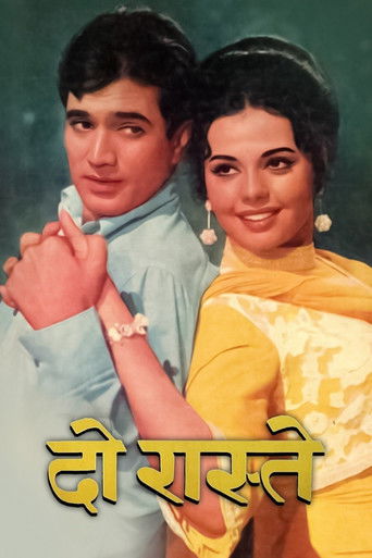 The poster features a man in a light blue shirt and a woman in a yellow saree, both smiling warmly. The vibrant colors and confident expressions convey a sense of romance and charm, suggesting a classic Bollywood film with a nostalgic feel.