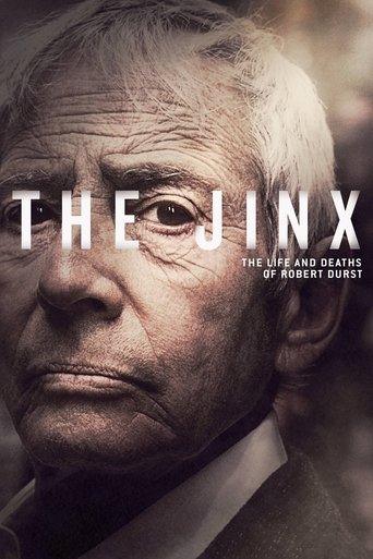 The Jinx poster features an elderly man with weathered skin and a somber expression, conveying a sense of mystery and tragedy. The muted, sepia-toned color palette enhances the historical and dramatic atmosphere, while the bold, white text of the title stands out against the dark background.