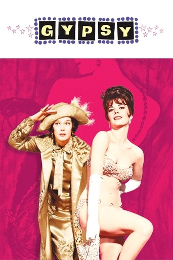 The poster features two glamorous women in vibrant pink and gold attire, exuding a dreamy, romantic atmosphere. The title "GYPSY" is prominently displayed at the top in bold, playful lettering.