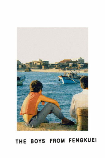 The poster features two boys sitting on a rocky shore, gazing out at a serene harbor. The warm orange shirt of one boy contrasts with the cool blue water, evoking a nostalgic, peaceful mood. The distant buildings and boats add depth to the tranquil scene, suggesting a quiet moment of reflection.