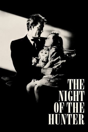 The black-and-white poster captures a dramatic scene of a man and woman in a dark, moody setting. The woman holds a small child, while the man looks on with a somber expression. The stark lighting and shadowy tones evoke a sense of mystery and tension. The title "The Night of the Hunter" is promi...