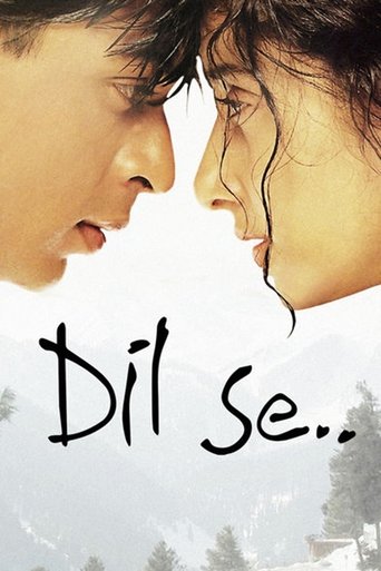 The poster features a tender, intimate close-up of two characters leaning in toward each other, their faces nearly touching. The soft, warm tones of their skin contrast with the muted, snowy background, evoking a sense of longing and emotional connection. The title "Dil Se.." is elegantly written...