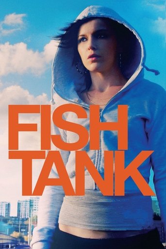 The poster features a young woman in a gray hoodie against a bright blue sky, exuding a cool, confident vibe. The bold orange text "FISH TANK" dominates the foreground, creating a striking contrast that hints at the film's themes of identity and self-discovery.