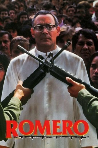 The poster features a man in a white shirt holding a rifle, with soldiers in green uniforms aiming it at him. The crowd in the background adds tension, and the bold red "ROMERO" text dominates the bottom, conveying a sense of authority and danger.