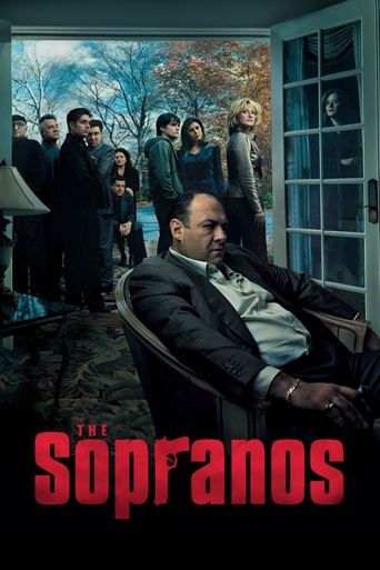 The poster features a somber scene with a man in a suit reclining in a chair, surrounded by a group of people in dark clothing. The muted tones of the image, combined with the red "Sópronos" text, evoke a tense and dramatic atmosphere.