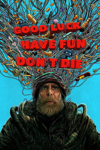 The poster features a rugged man with a thick beard and steampunk-inspired goggles, surrounded by chaotic wires, tools, and gadgets. The bold red text "GOOD LUCK HAVE FUN DON'T DIE" dominates the top, evoking a humorous yet adventurous tone against a vivid blue background.