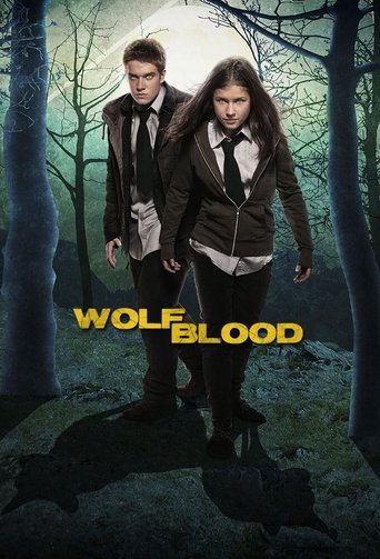 The poster features two young characters in school uniforms walking through a dark, eerie forest at night. The title "Wolfblood" is prominently displayed in bold yellow letters. The overall mood is mysterious and suspenseful, with a mysterious atmosphere that hints at supernatural elements.