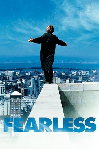 The poster features a lone figure standing atop a high-rise building, arms outstretched against a vast, serene sky. The bold blue title "Fearless" anchors the bottom, evoking a sense of freedom and courage.