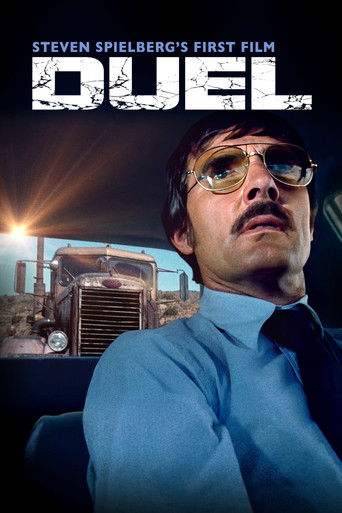 The poster features a man with glasses and a mustache, wearing a blue shirt against a dark background. The title "DUEL" is prominently displayed in bold, distressed white letters. The overall mood is intense and dramatic, with a sense of urgency and conflict.
