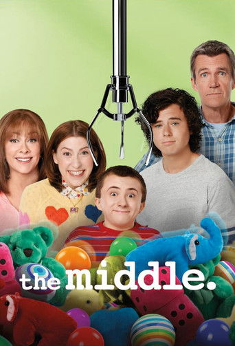 The poster features a group of six characters in a cheerful, vibrant setting. The background is a soft green, while colorful toys and stuffed animals fill the foreground, creating a lively atmosphere. The characters' expressions convey happiness and camaraderie, suggesting a warm, family-oriented...
