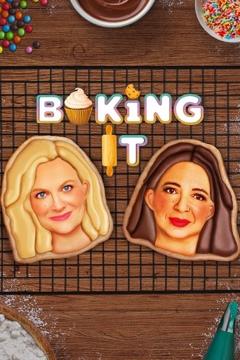 This TV show poster for "Baking It" features two smiling faces on cookie dough, evoking a warm, inviting atmosphere. The pastel colors and cheerful expressions create a fun and approachable vibe, perfect for baking enthusiasts.